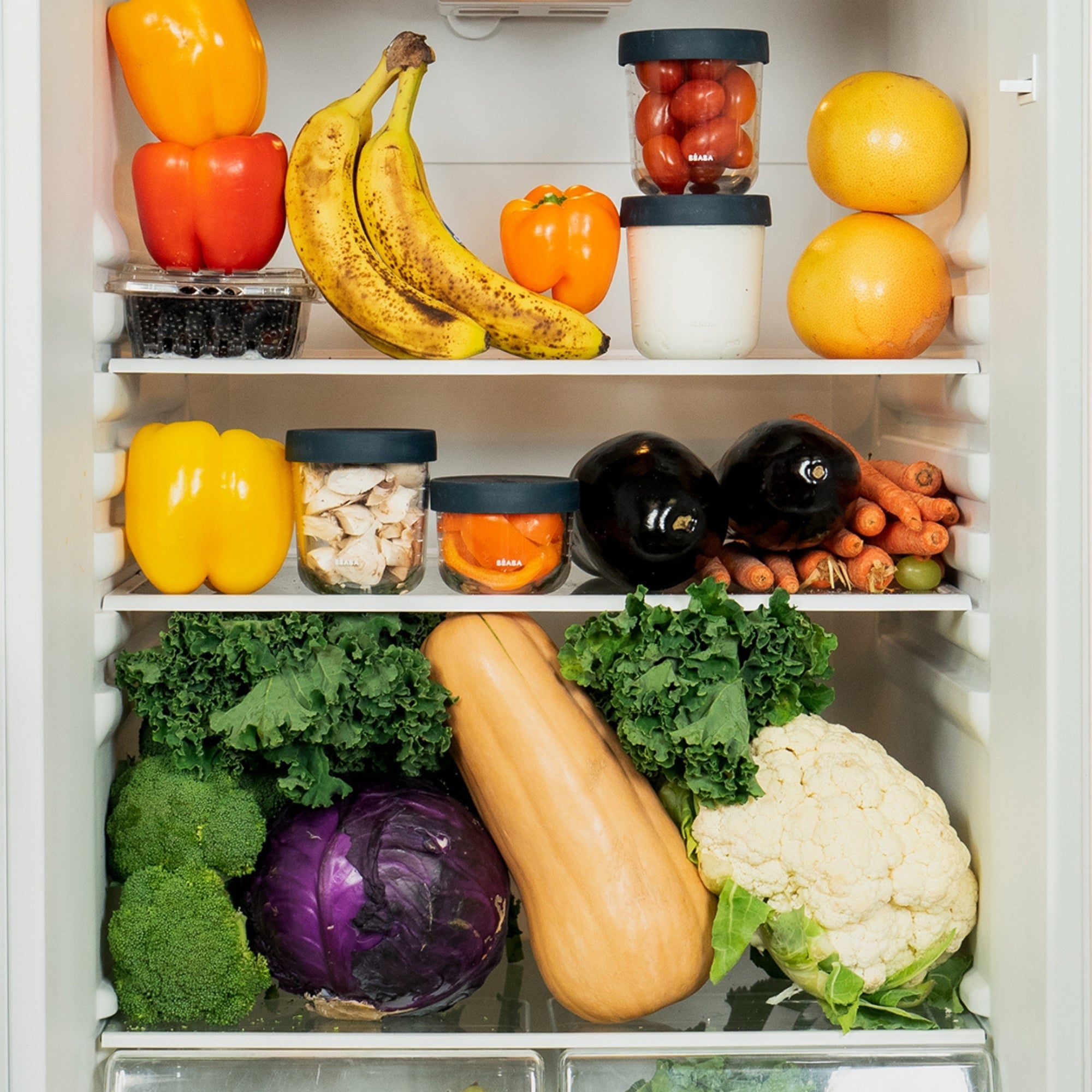 Colorful fruits and veggies inside of a refrigerator